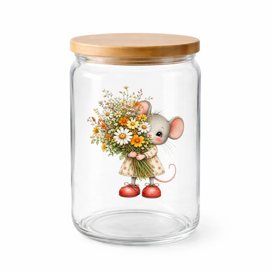 Mouse In Floral Dress Holding Flowers UV DTF sticker applied to a clear glass jar with a wooden lid