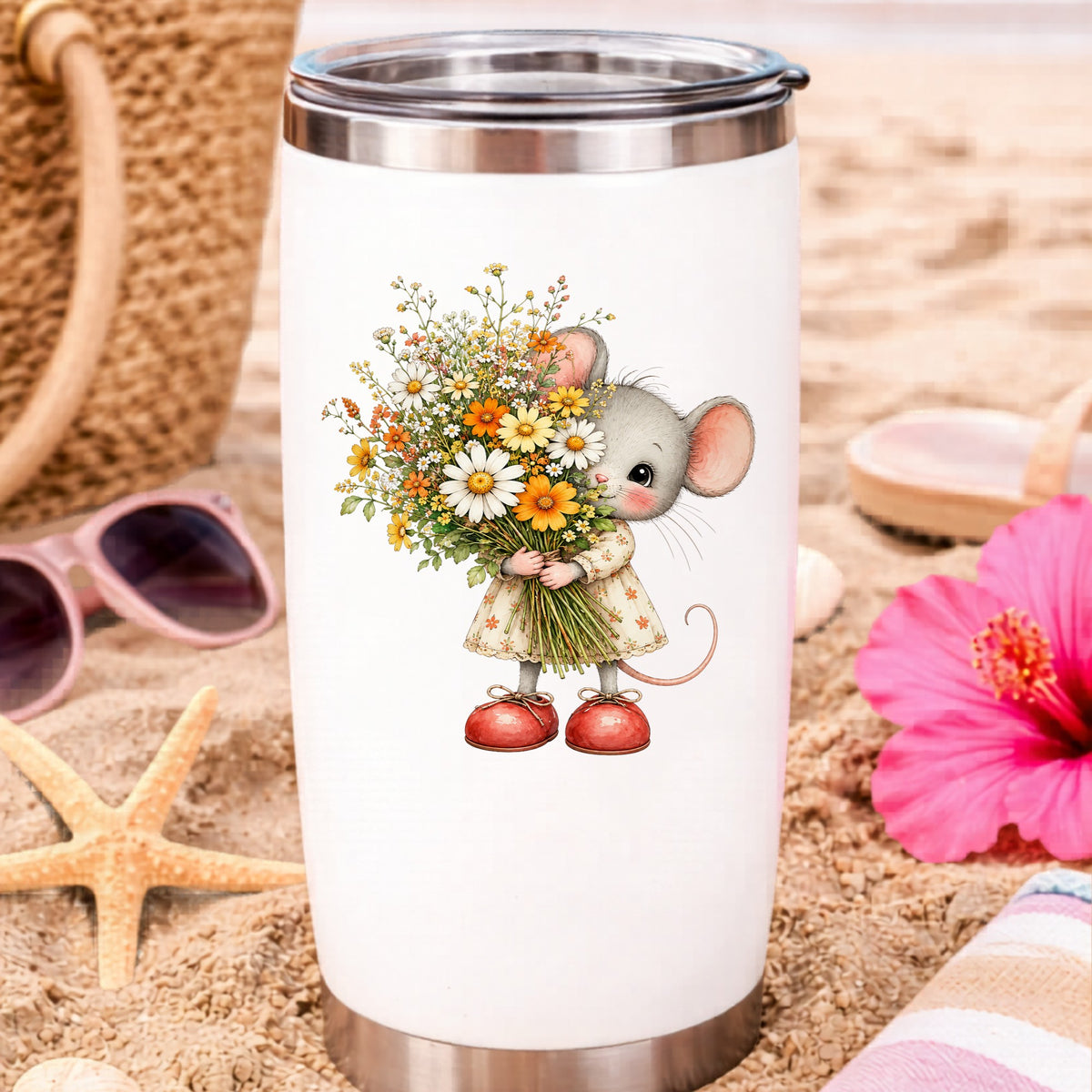 Mouse In Floral Dress Holding Flowers UV DTF sticker applied to a white travel tumbler on beach sand
