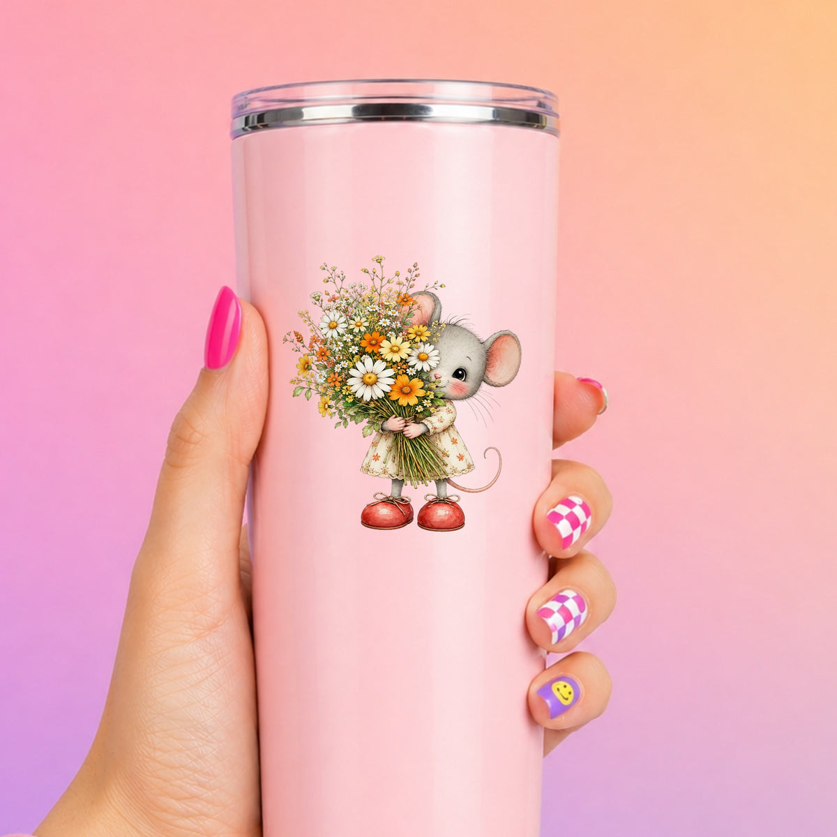 Mouse In Floral Dress Holding Flowers UV DTF sticker applied to a tall pink tumbler on a pink and orange background