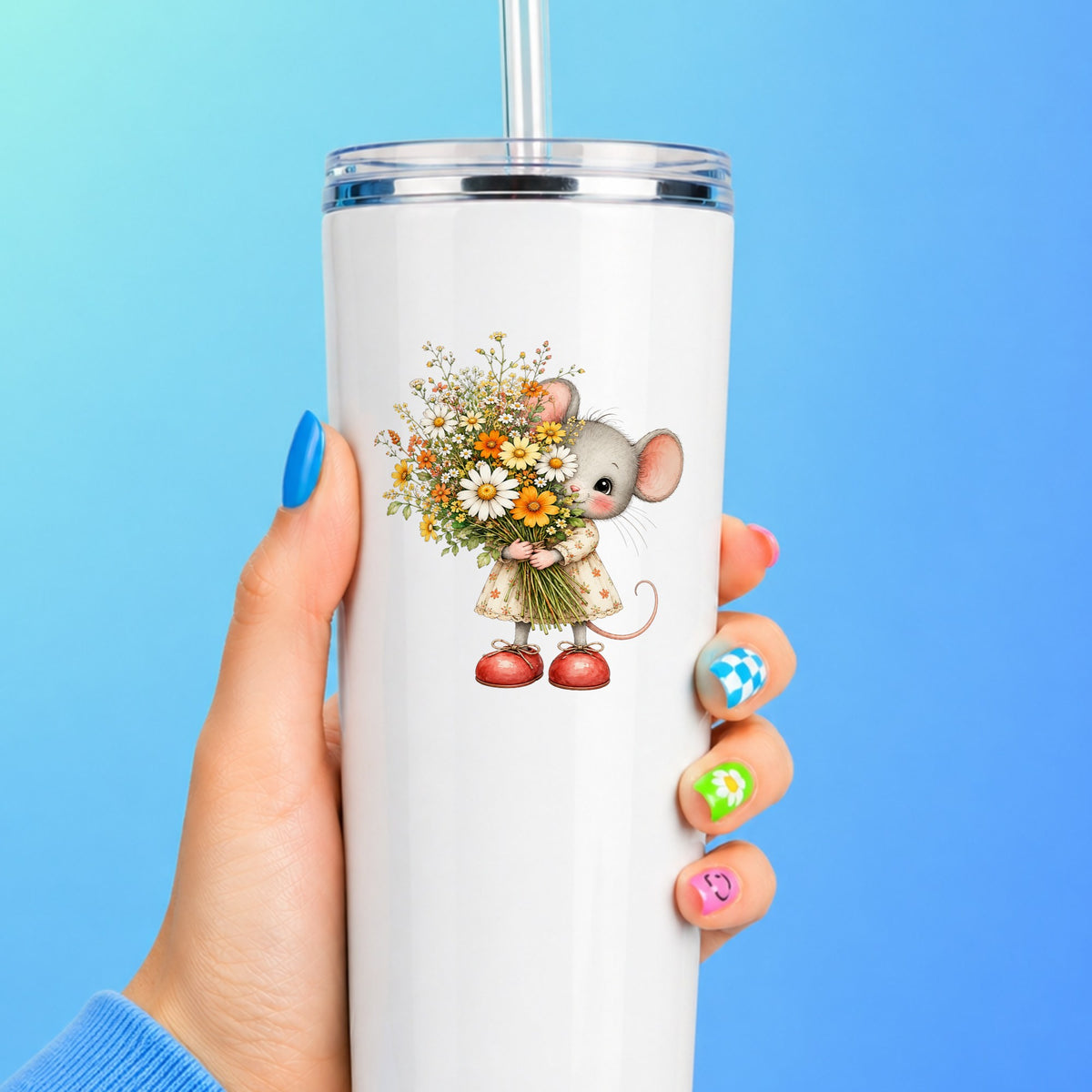 Mouse In Floral Dress Holding Flowers UV DTF sticker applied to a white straw tumbler on a blue background