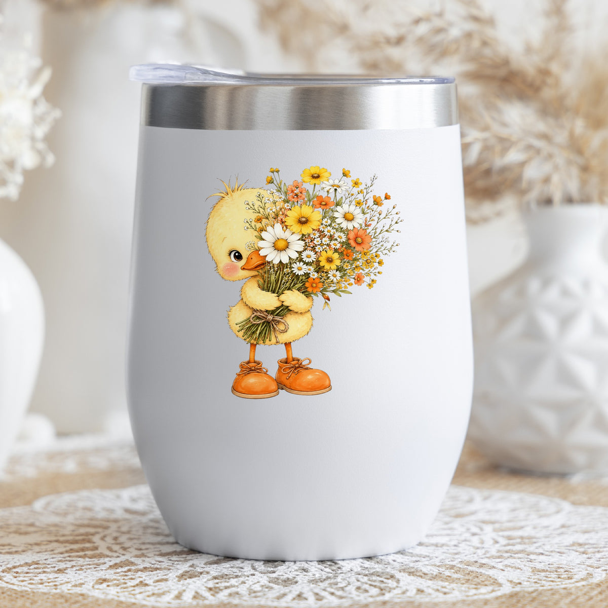 Baby Duck Holding Wildflower Bouquet UV DTF sticker applied to a white stemless tumbler with a lid
