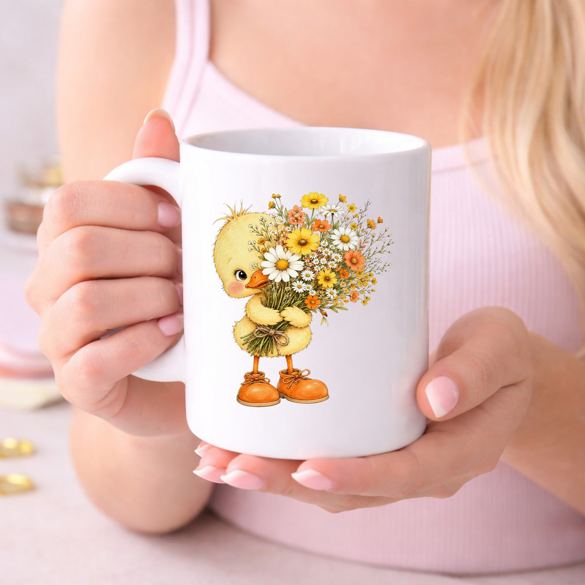 Baby Duck Holding Wildflower Bouquet UV DTF sticker applied to a white coffee mug held in both hands