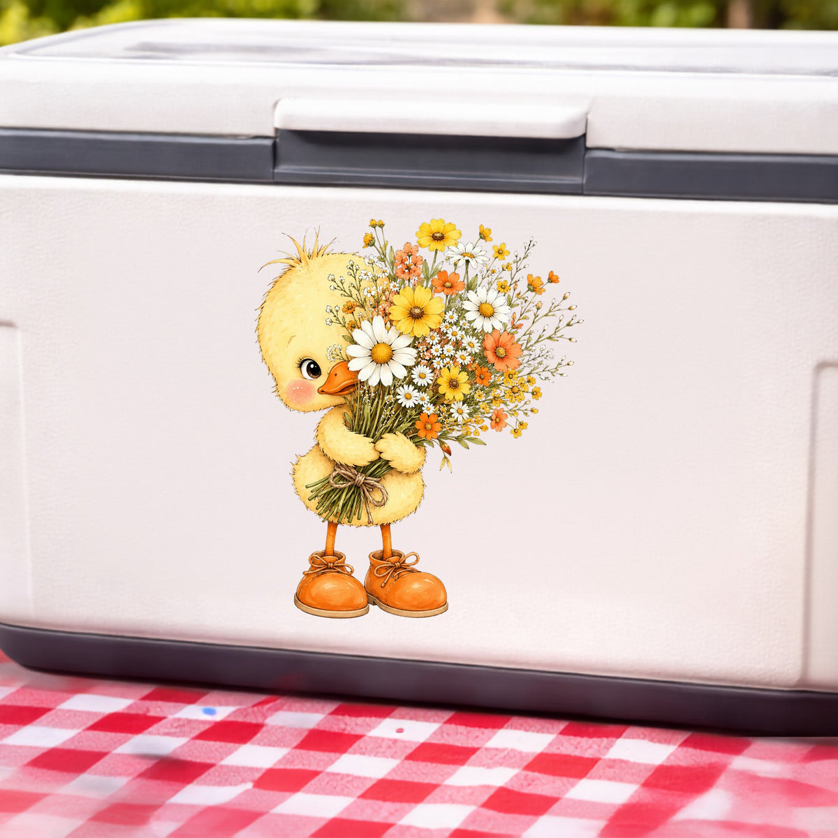 Baby Duck Holding Wildflower Bouquet UV DTF sticker applied to a white cooler on a red gingham cloth