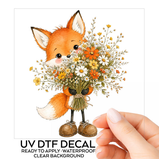 Orange Fox Holding Flower Bouquet UV DTF sticker on its backing card, held in hand