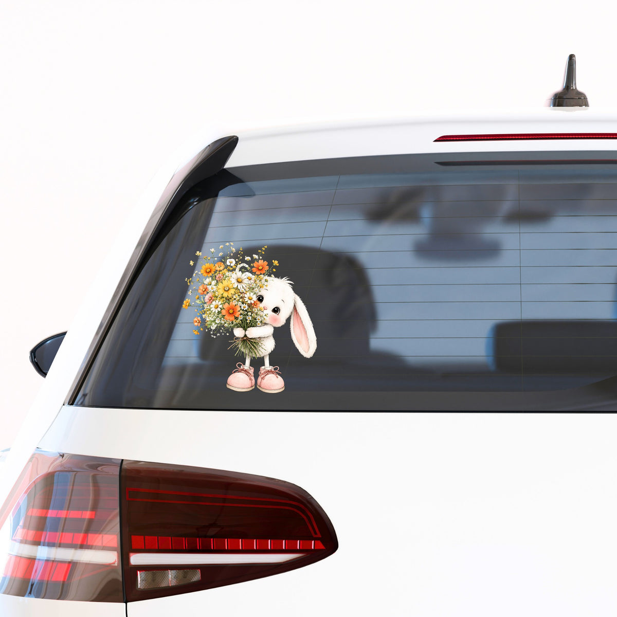 Baby Bunny Holding Daisy Bouquet UV DTF sticker applied to the rear window of a white car