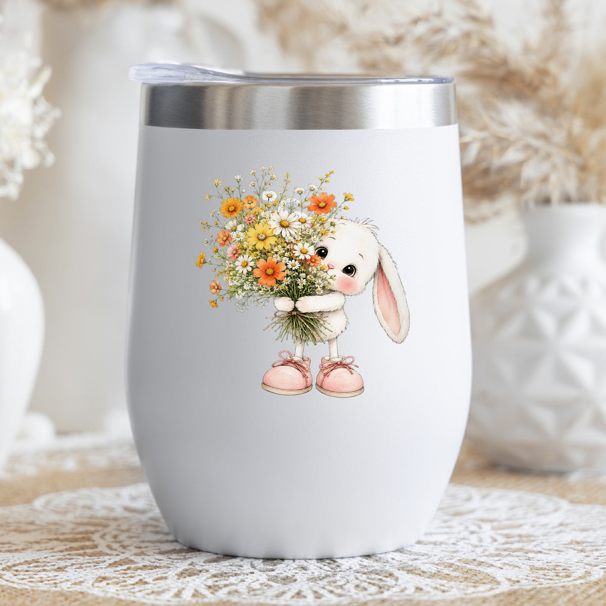 Baby Bunny Holding Daisy Bouquet UV DTF sticker applied to a white stemless tumbler with a lid
