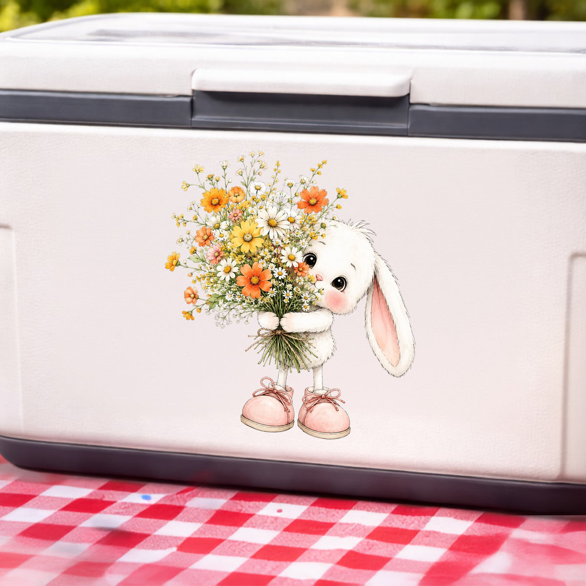 Baby Bunny Holding Daisy Bouquet UV DTF sticker applied to a white cooler on a red gingham cloth