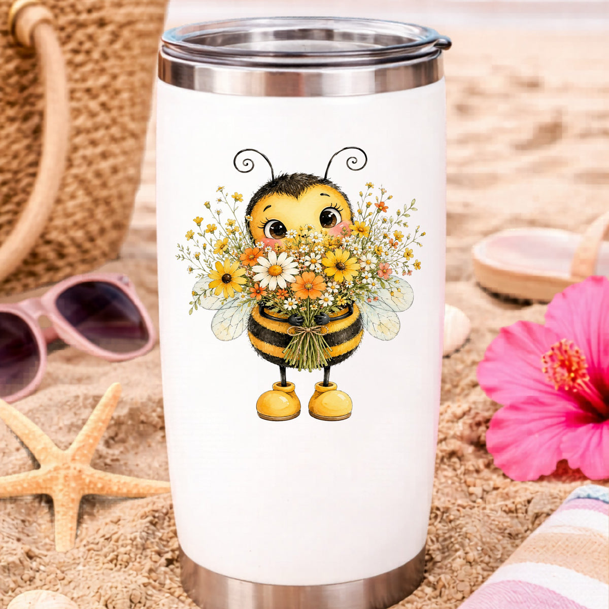 Bumble Bee Holding Daisy Bouquet UV DTF sticker applied to a white travel tumbler on beach sand