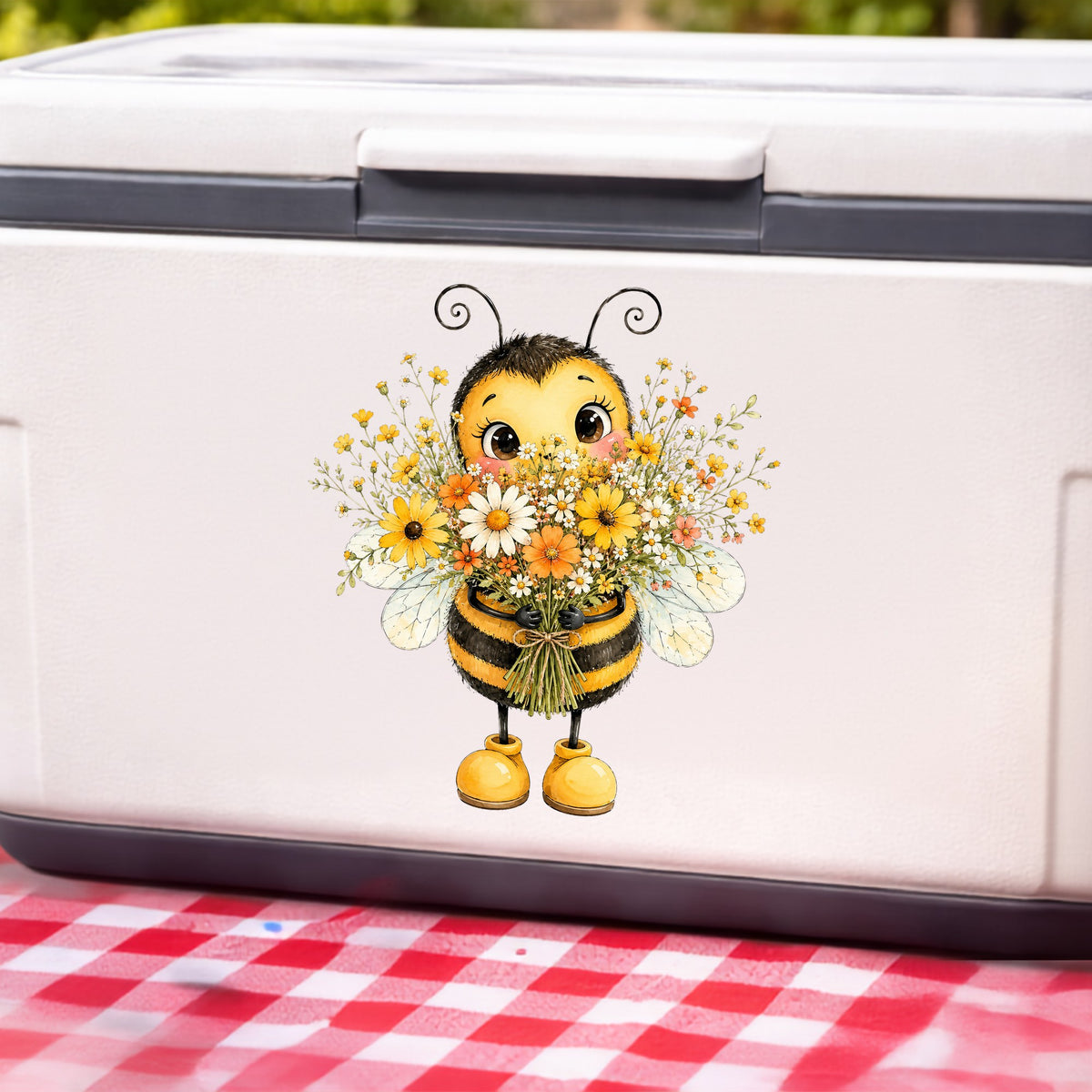 Bumble Bee Holding Daisy Bouquet UV DTF sticker applied to a white cooler on a red gingham cloth