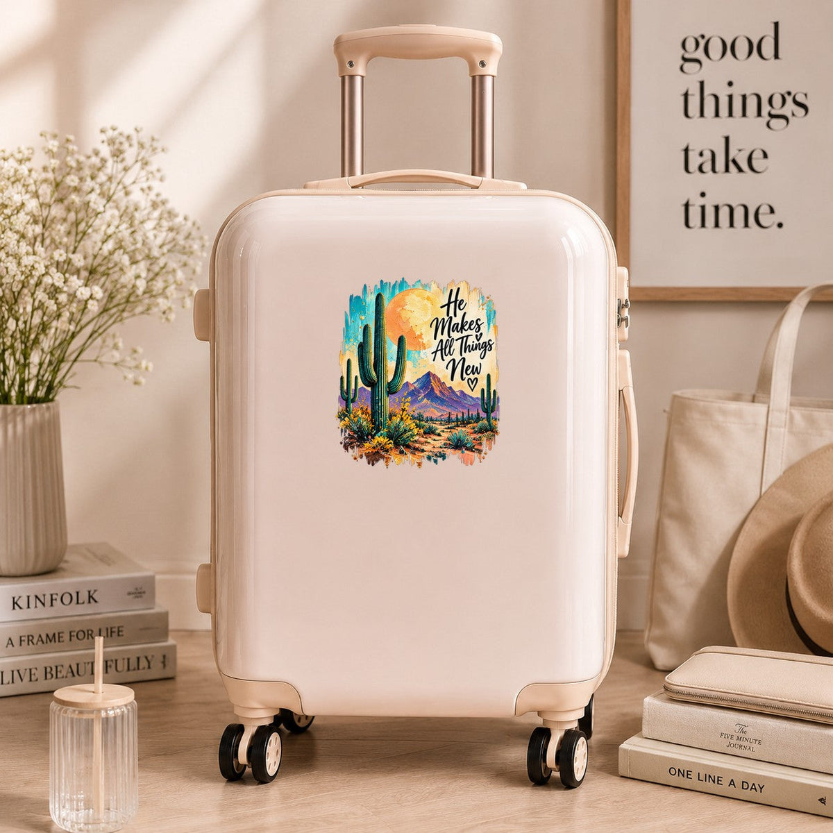 He Makes All Things New desert cactus UV DTF sticker on a neutral suitcase
