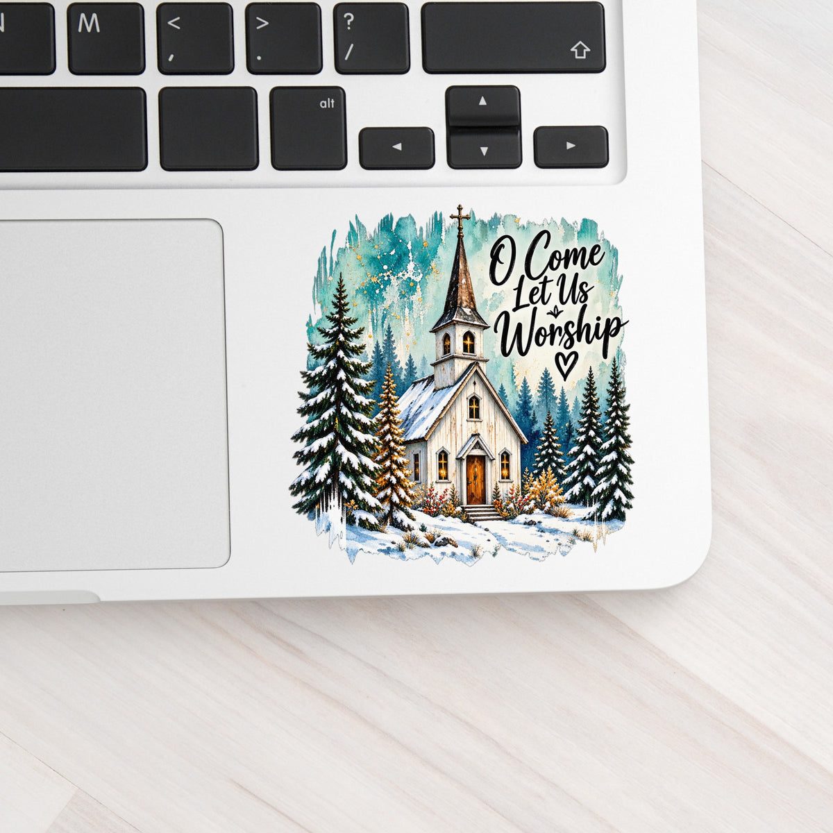 Snowy Country Church UV DTF sticker applied to a silver laptop beside the keyboard