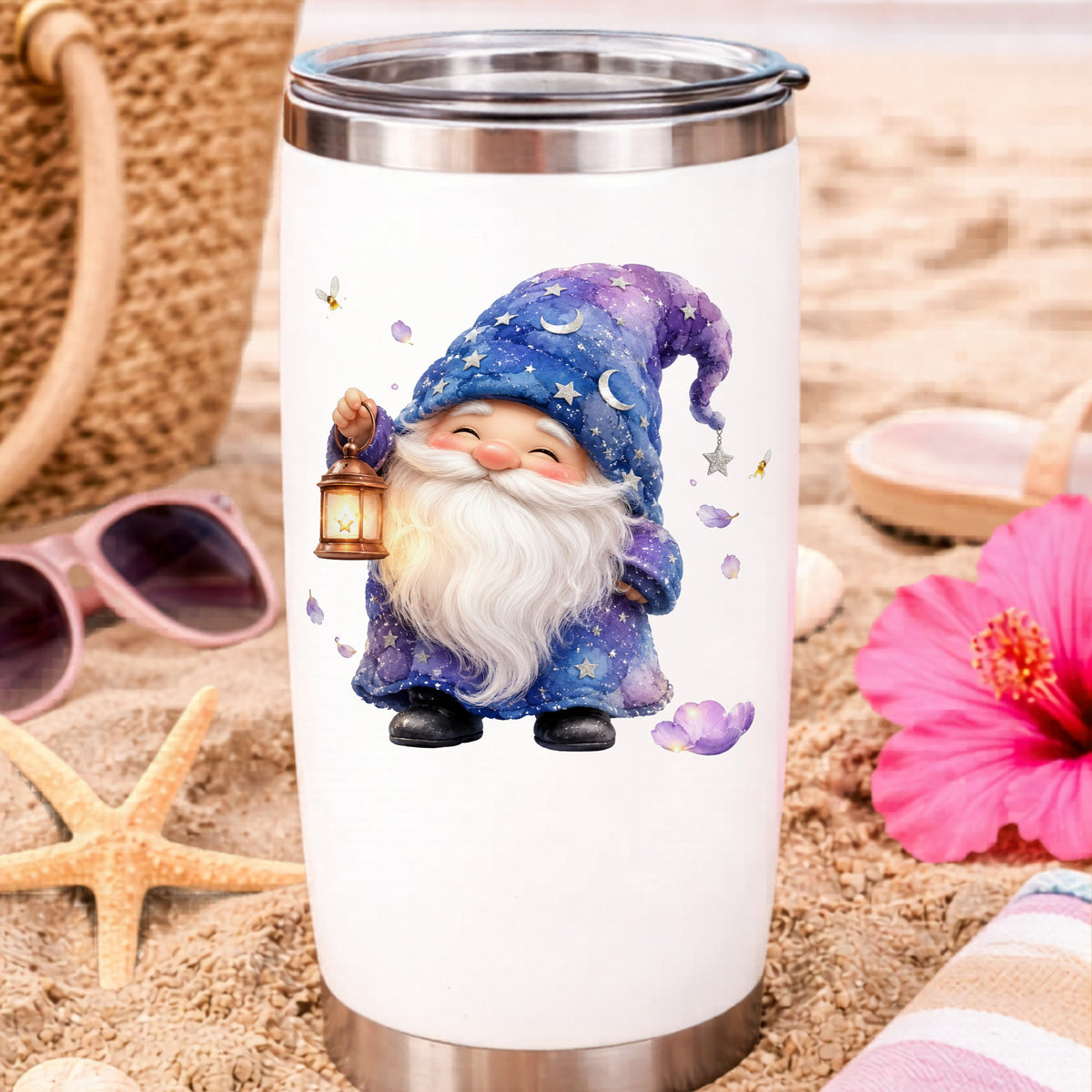 Gnome Holding A Lantern UV DTF sticker applied to a white travel tumbler on beach sand