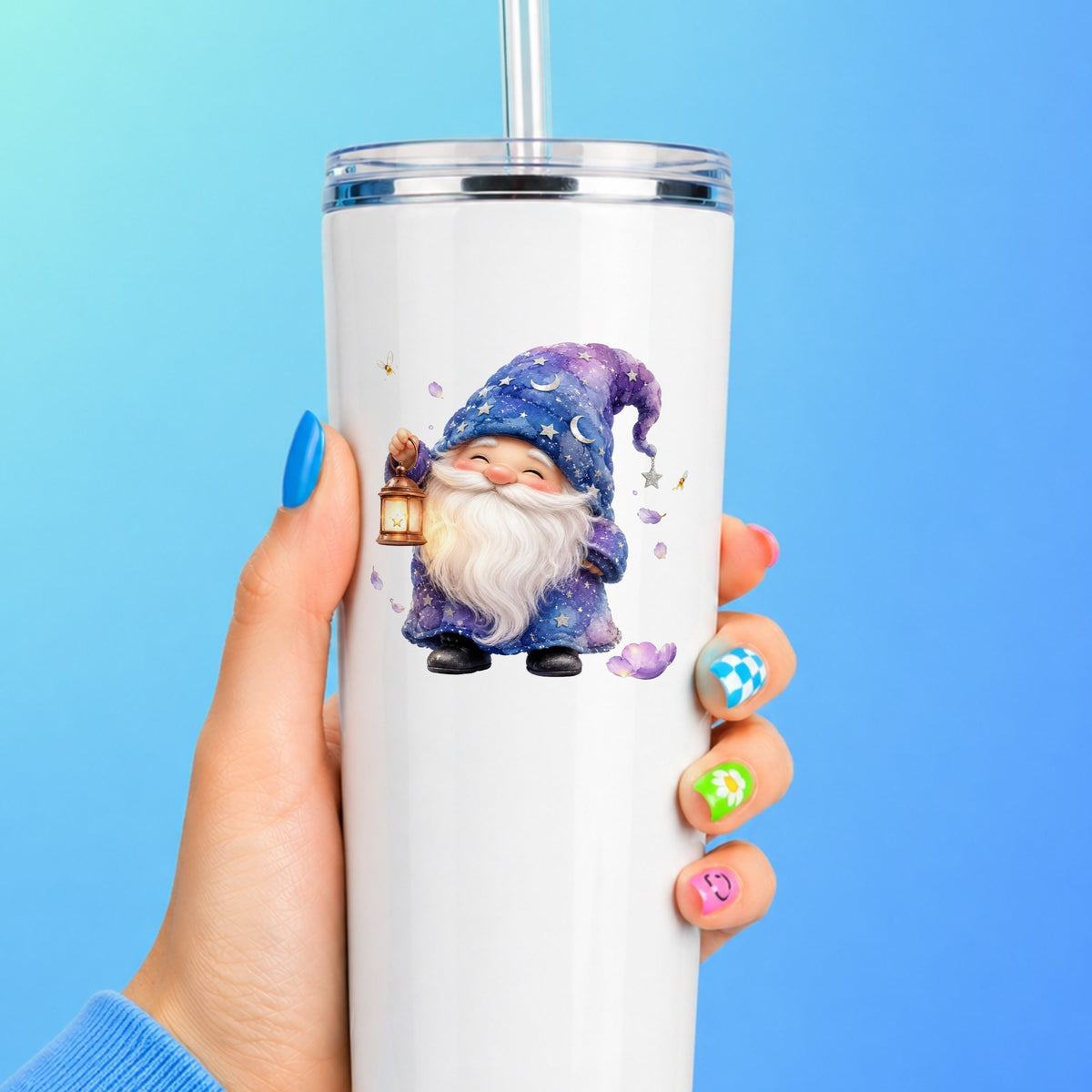 Gnome Holding A Lantern UV DTF sticker applied to a white straw tumbler on a blue background