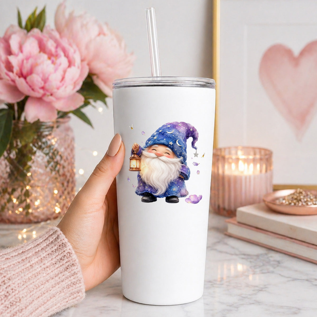 Gnome Holding A Lantern UV DTF sticker applied to a white straw tumbler beside pink peonies