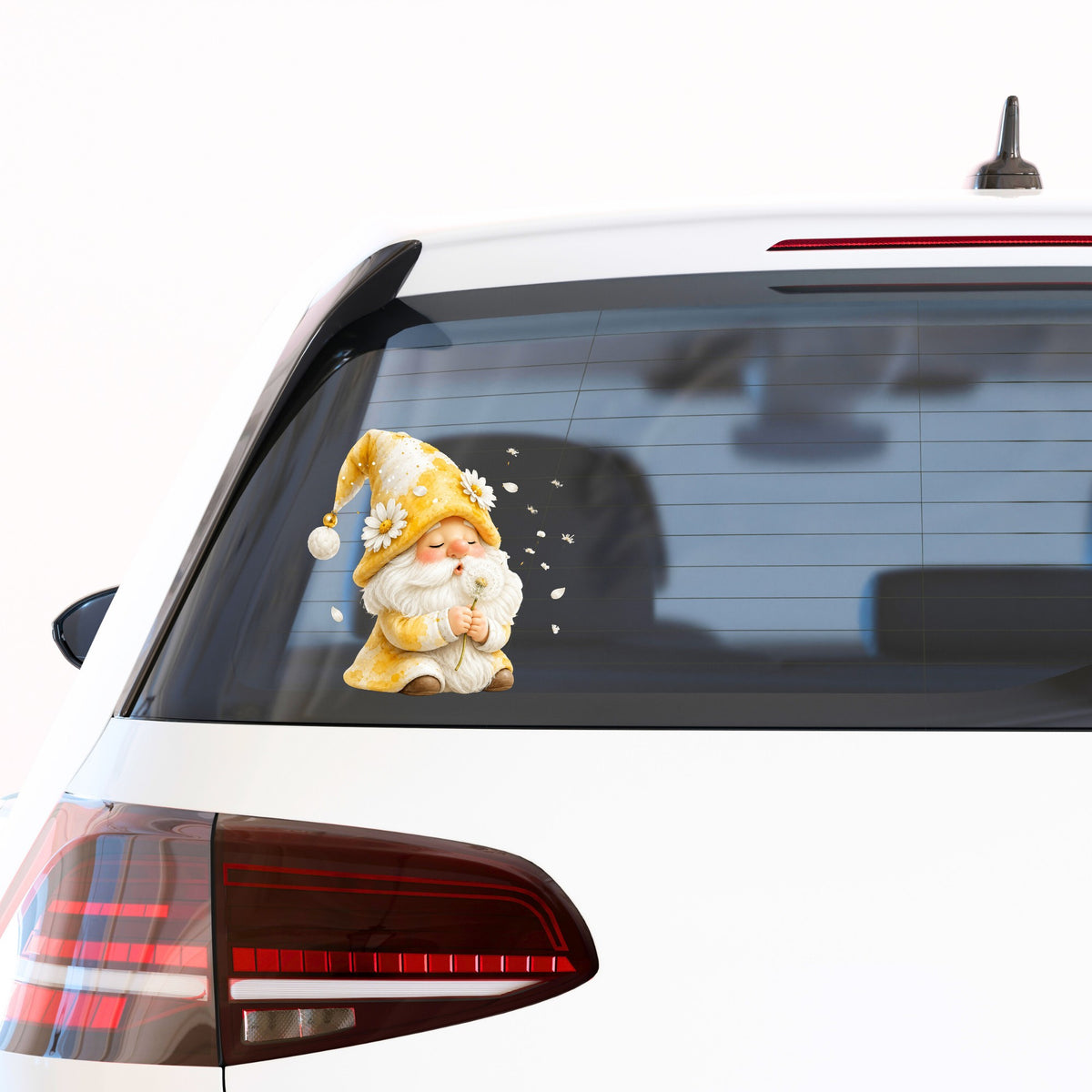 Gnome Blowing A Dandelion UV DTF sticker applied to the rear window of a white car