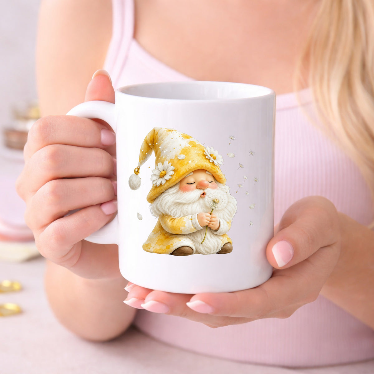Gnome Blowing A Dandelion UV DTF sticker applied to a white coffee mug held in both hands