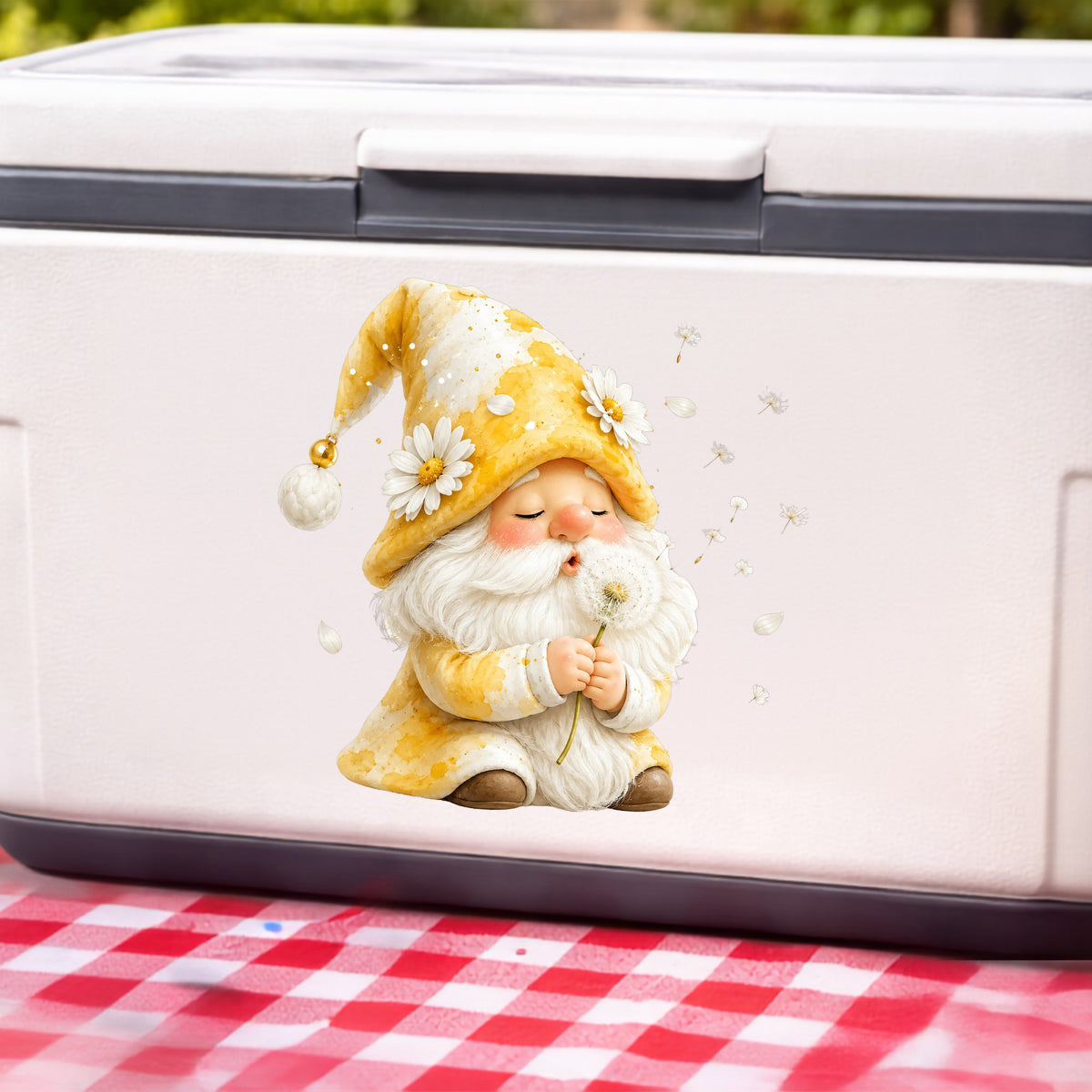 Gnome Blowing A Dandelion UV DTF sticker applied to a white cooler on a red gingham cloth