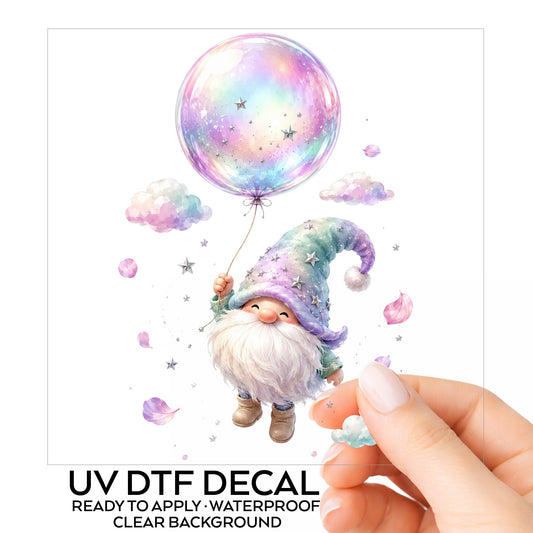 Gnome With Rainbow Bubble Balloon UV DTF sticker on its backing card, held in hand