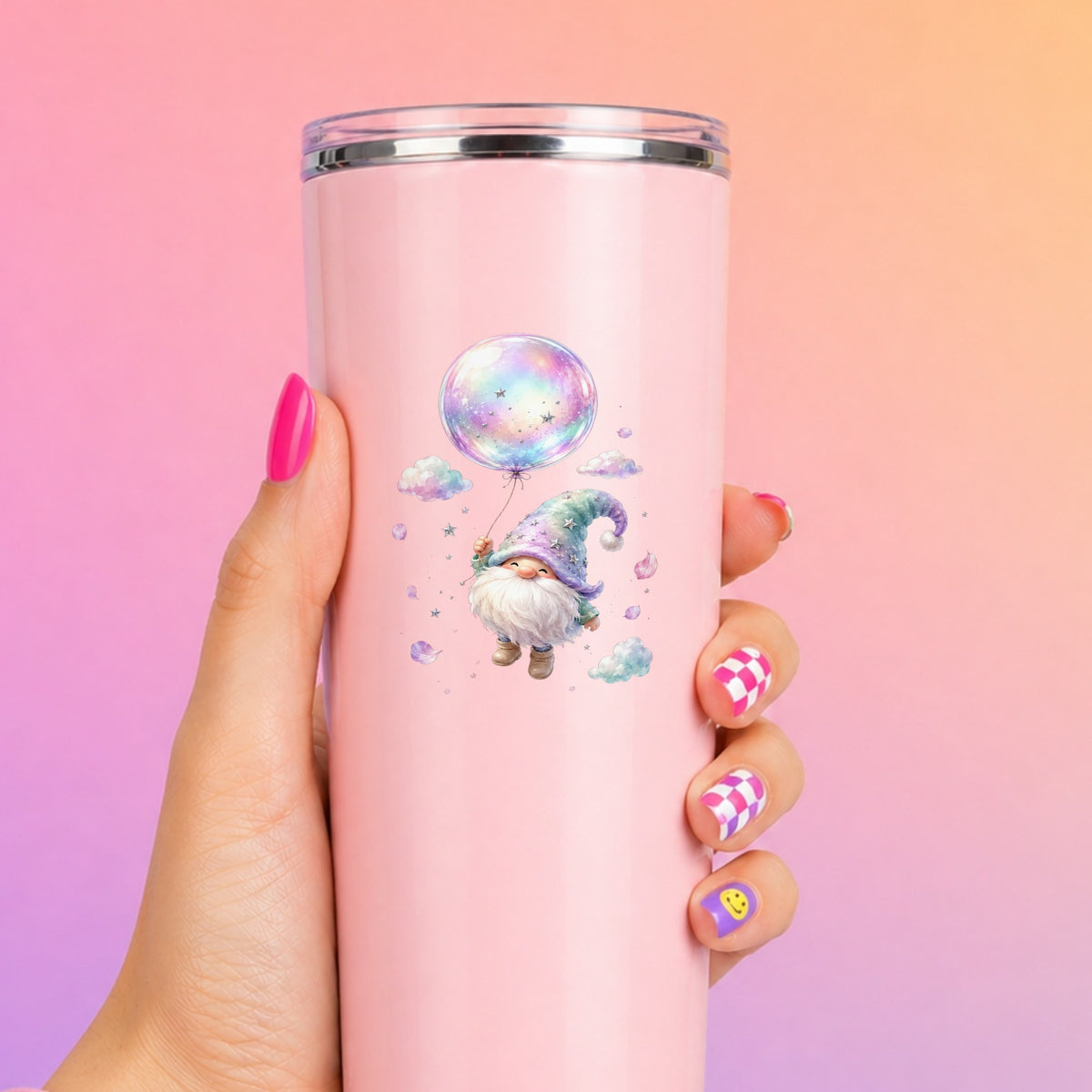 Gnome With Rainbow Bubble Balloon UV DTF sticker applied to a tall pink tumbler on a pink and orange background