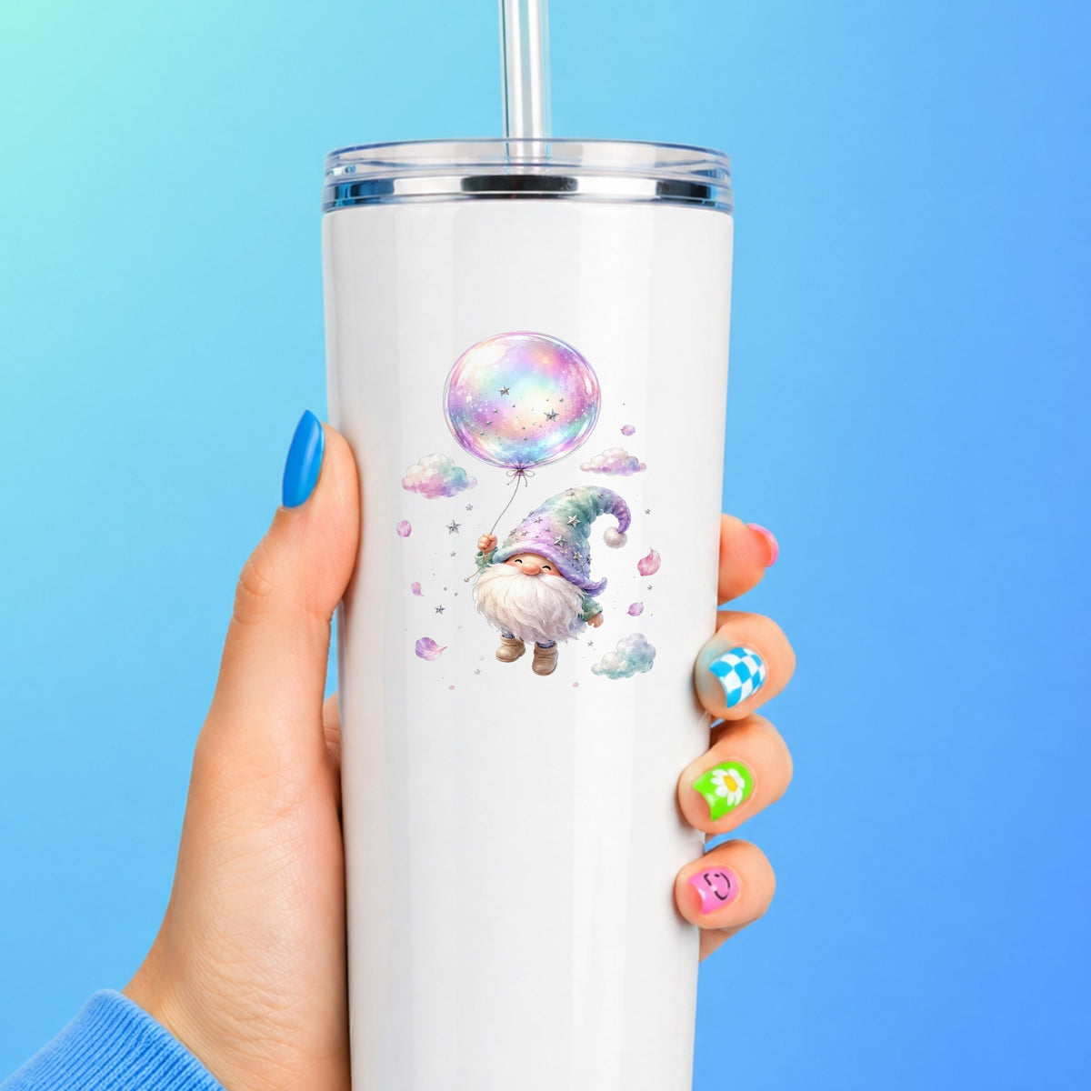 Gnome With Rainbow Bubble Balloon UV DTF sticker applied to a white straw tumbler on a blue background