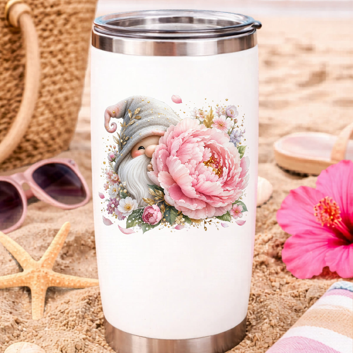 Gnome With Pink Peony UV DTF sticker applied to a white travel tumbler on beach sand