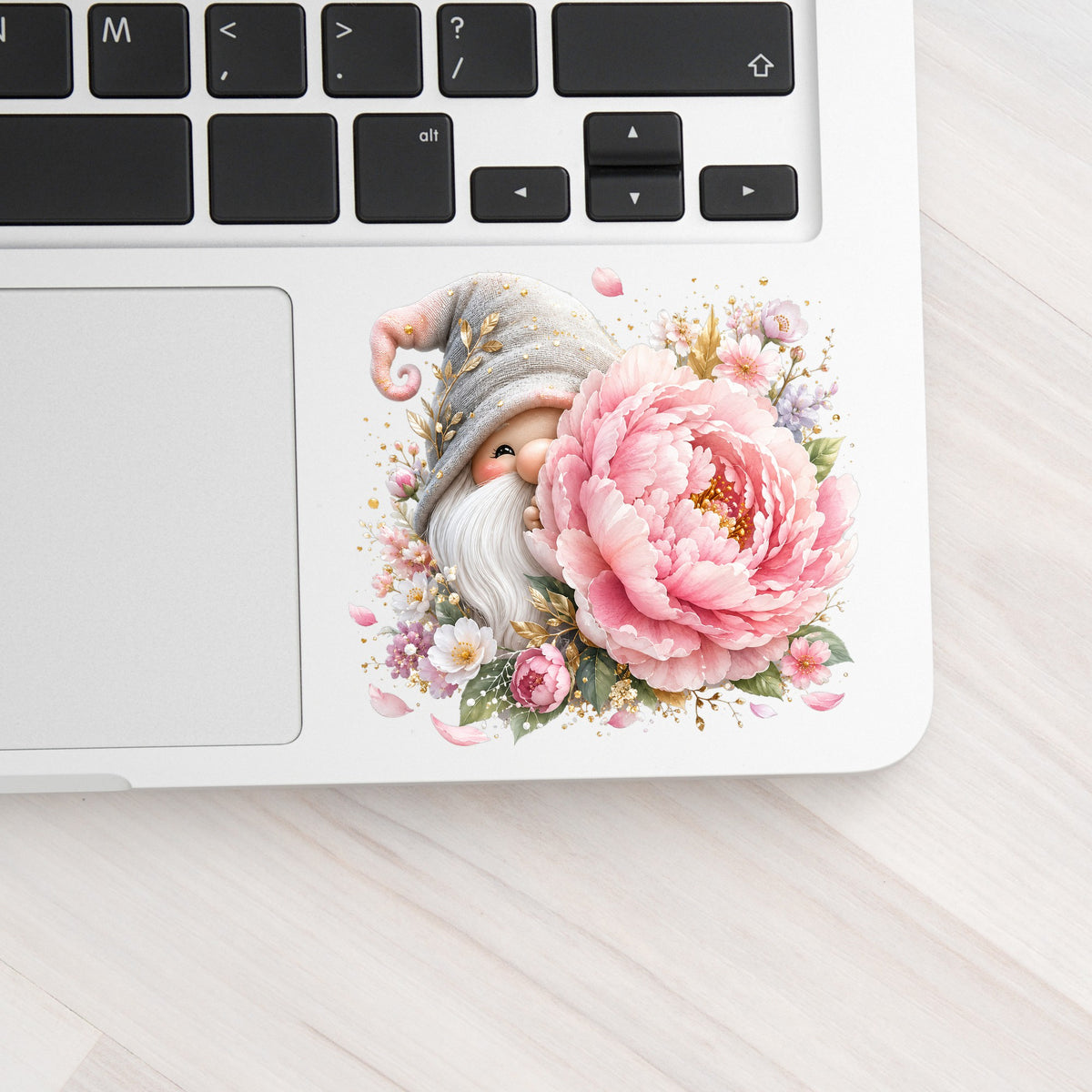 Gnome With Pink Peony UV DTF sticker applied to a silver laptop beside the keyboard