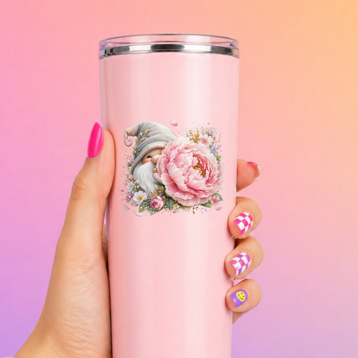 Gnome With Pink Peony UV DTF sticker applied to a tall pink tumbler on a pink and orange background