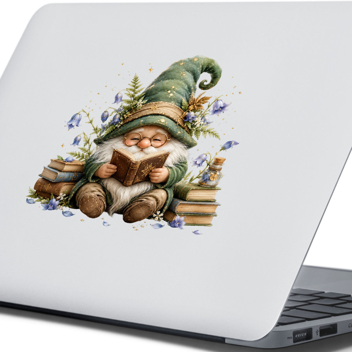 Gnome Reading With Book Stack UV DTF sticker applied to the lid of a silver laptop