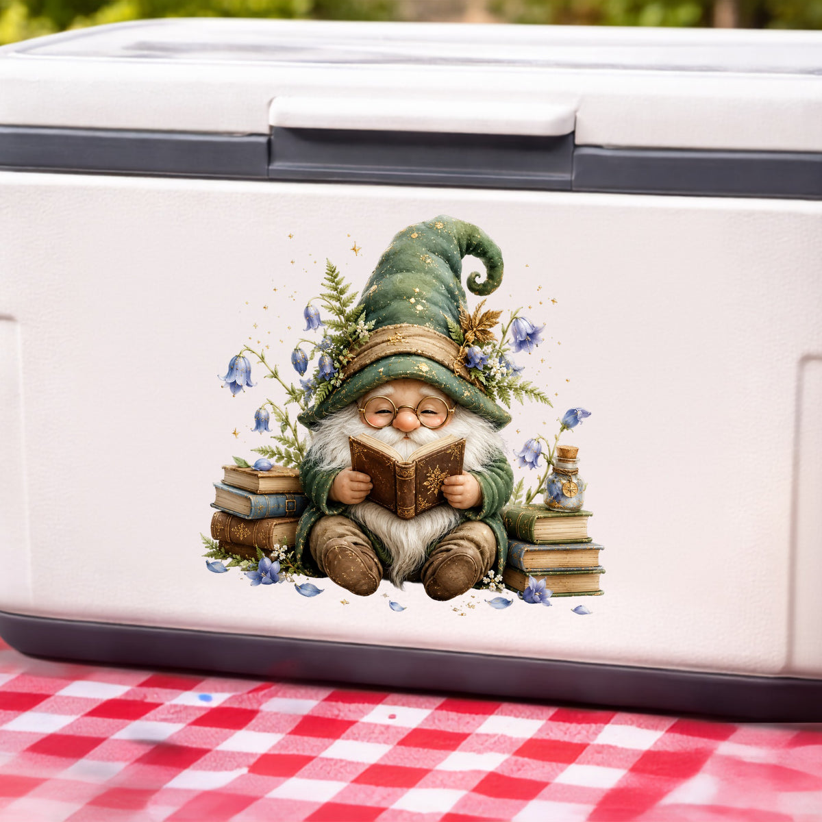 Gnome Reading With Book Stack UV DTF sticker applied to a white cooler on a red gingham cloth