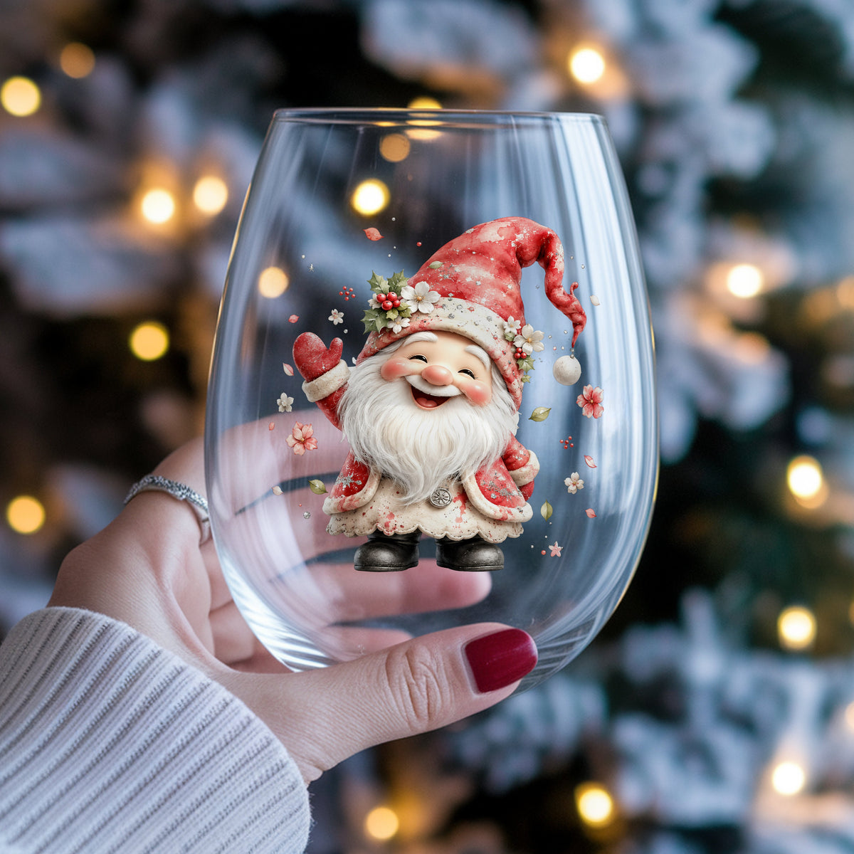Red Christmas Gnome UV DTF sticker applied to a stemless wine glass held in hand