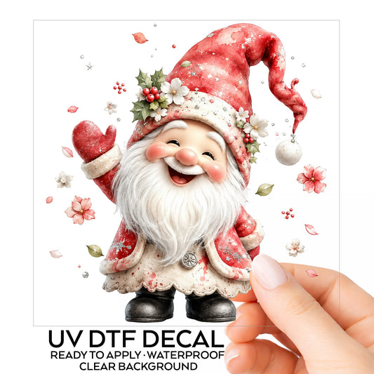 Red Christmas Gnome UV DTF sticker on its backing card, held in hand