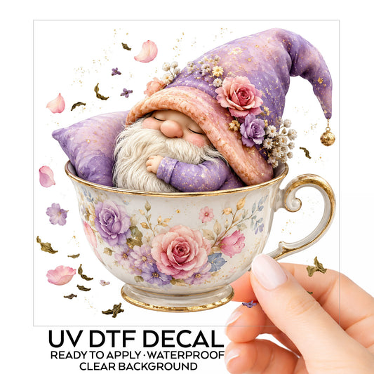 Gnome Sleeping In Teacup UV DTF sticker on its backing card, held in hand