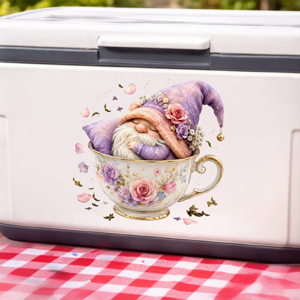 Gnome Sleeping In Teacup UV DTF sticker applied to a white cooler on a red gingham cloth