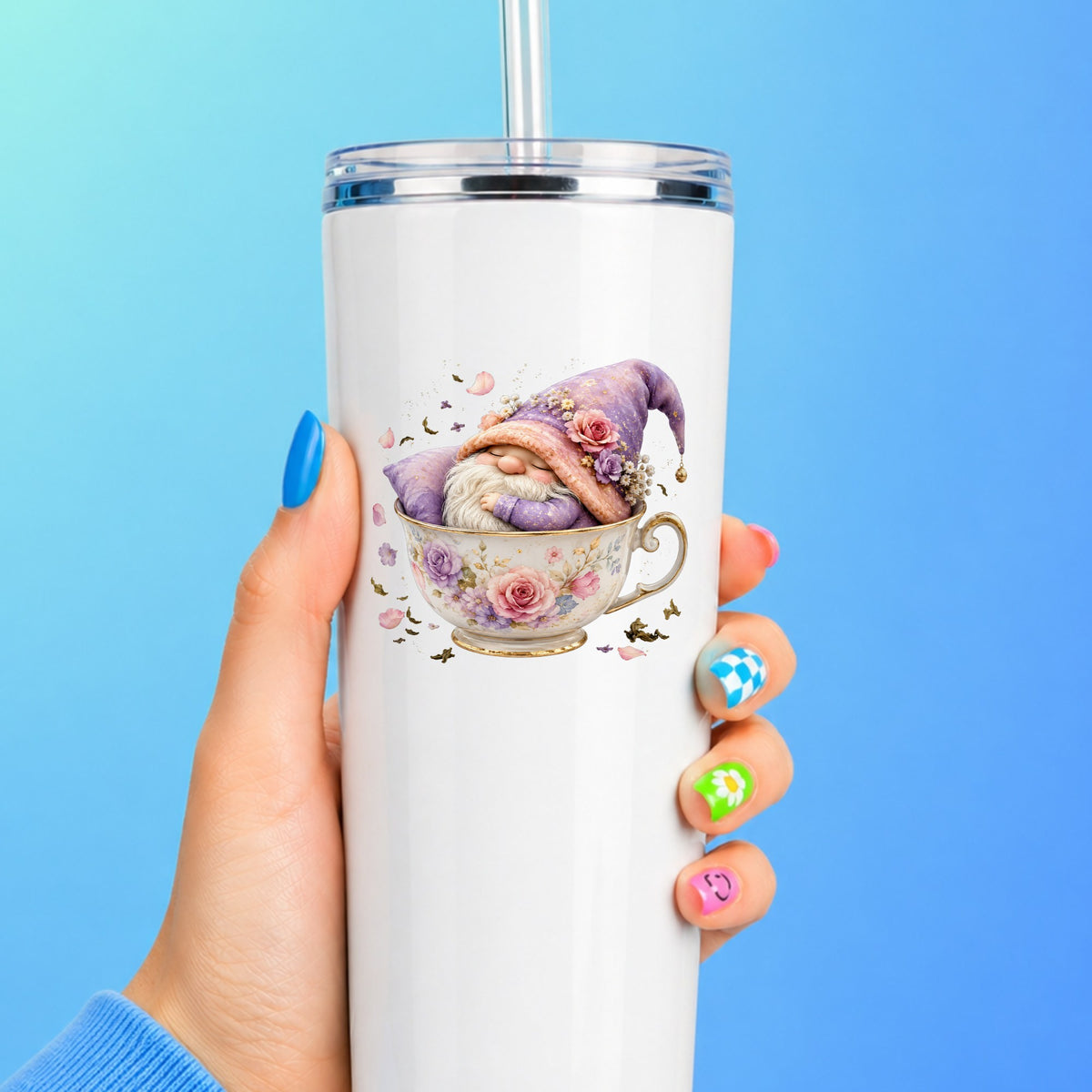 Gnome Sleeping In Teacup UV DTF sticker applied to a white straw tumbler on a blue background