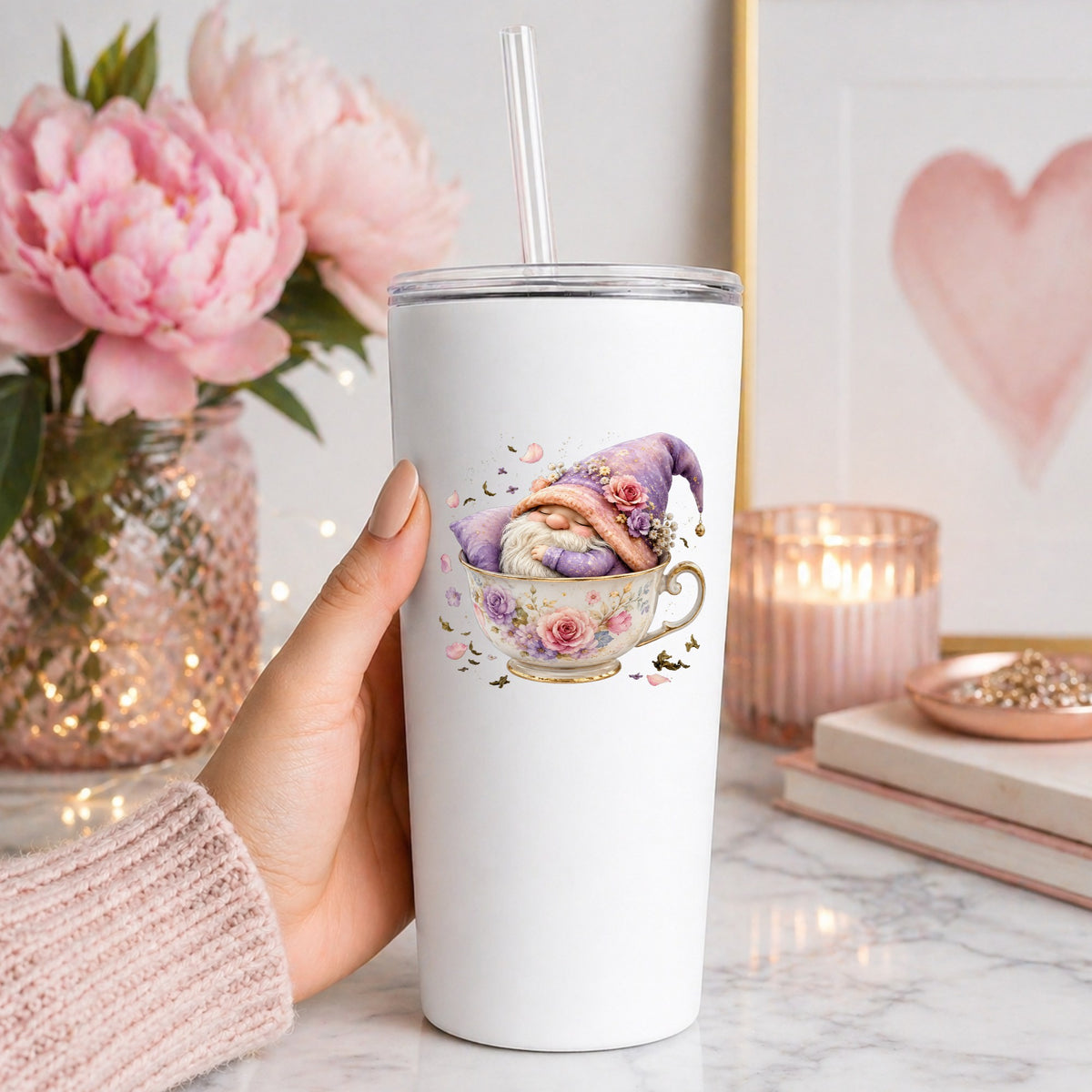 Gnome Sleeping In Teacup UV DTF sticker applied to a white straw tumbler beside pink peonies