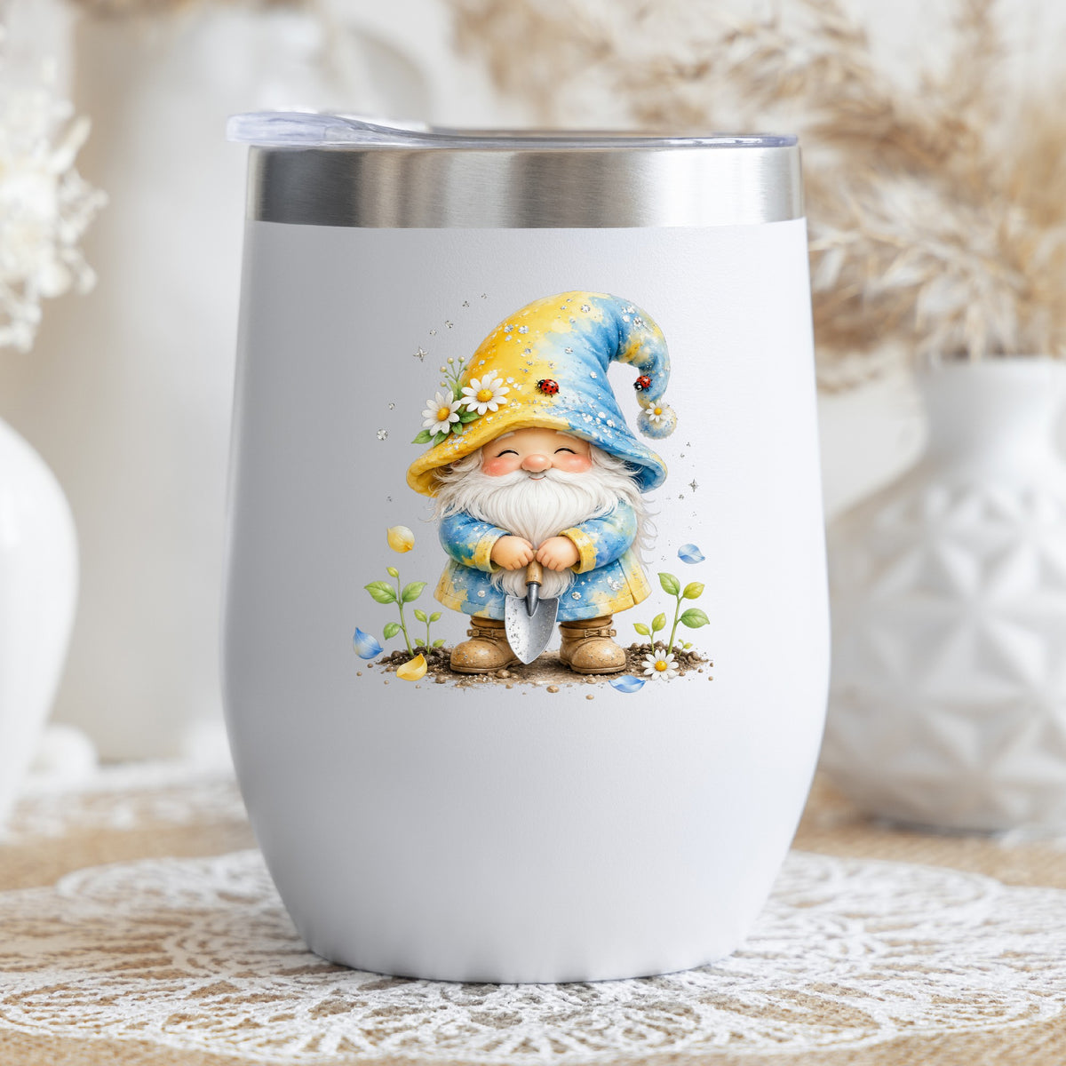 Gardening Gnome With Trowel UV DTF sticker applied to a white stemless tumbler with a lid