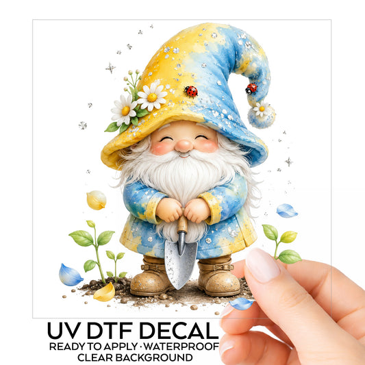 Gardening Gnome With Trowel UV DTF sticker on its backing card, held in hand