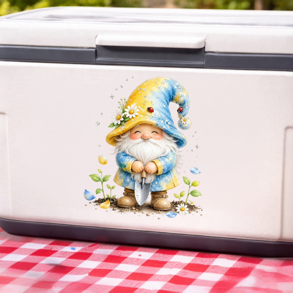 Gardening Gnome With Trowel UV DTF sticker applied to a white cooler on a red gingham cloth