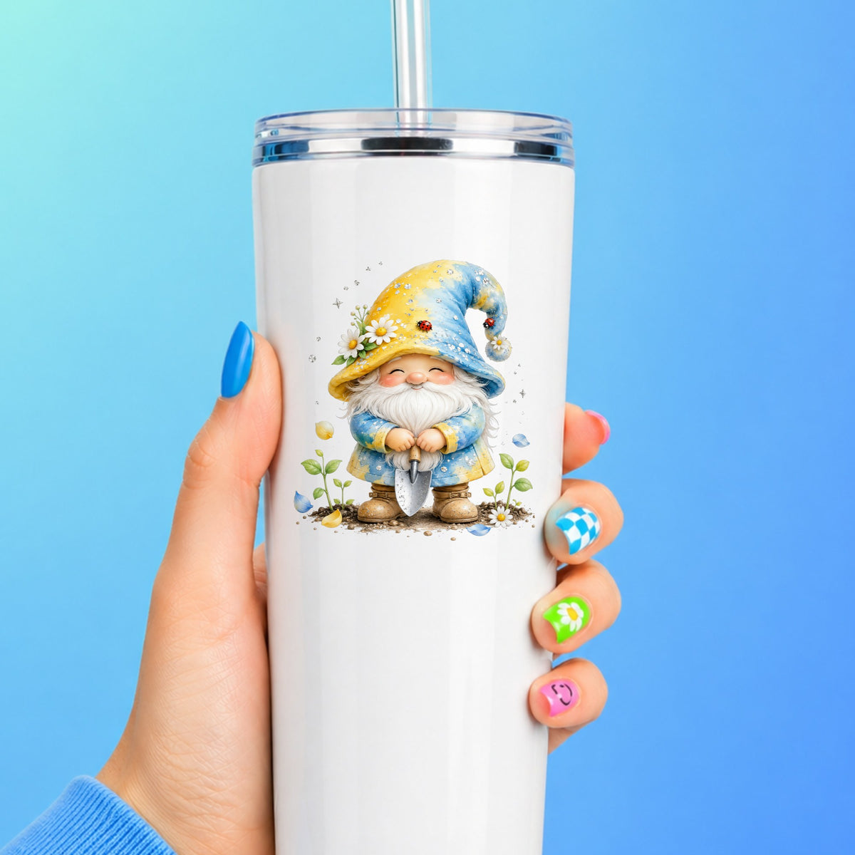Gardening Gnome With Trowel UV DTF sticker applied to a white straw tumbler on a blue background