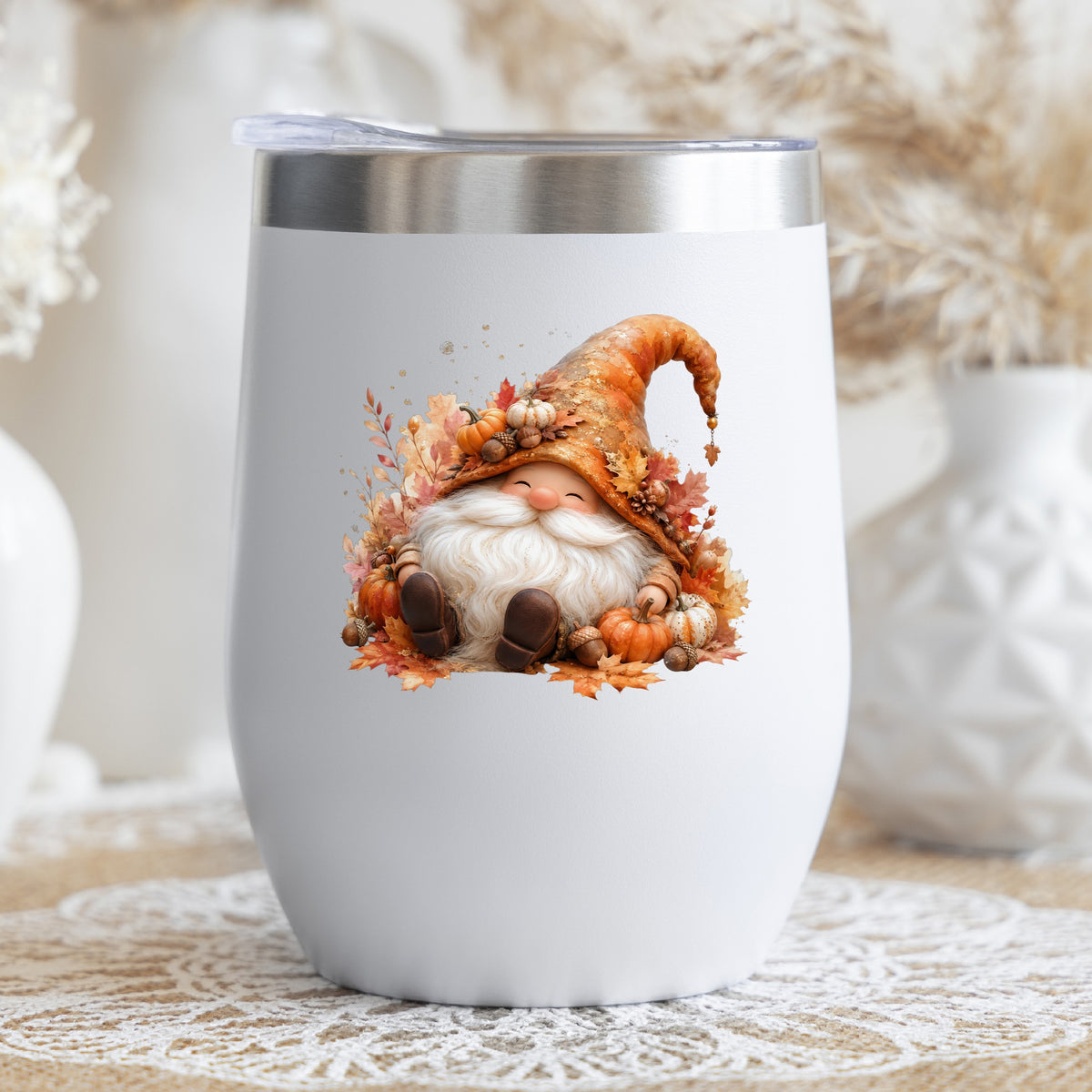 Autumn Gnome With Pumpkins UV DTF sticker applied to a white stemless tumbler with a lid