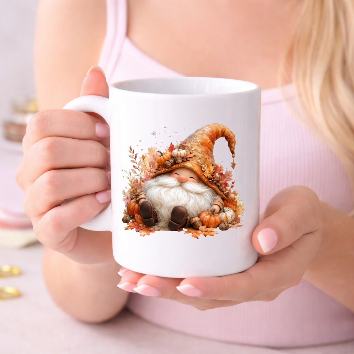 Autumn Gnome With Pumpkins UV DTF sticker applied to a white coffee mug held in both hands