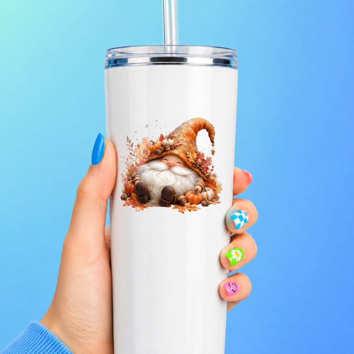 Autumn Gnome With Pumpkins UV DTF sticker applied to a white straw tumbler on a blue background