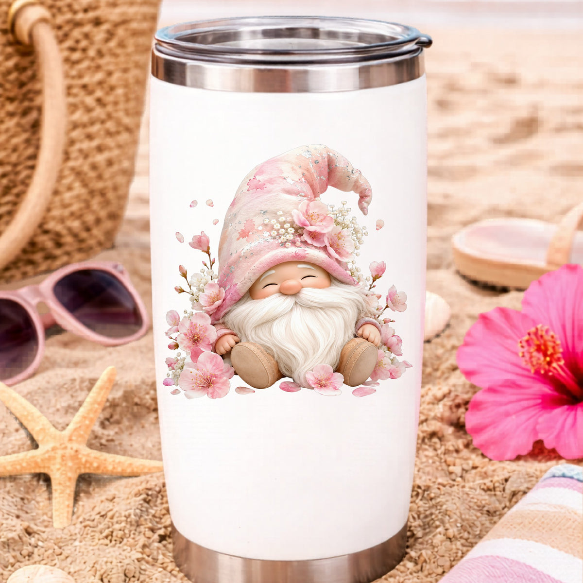 Cherry Blossom Gnome UV DTF sticker applied to a white travel tumbler on beach sand