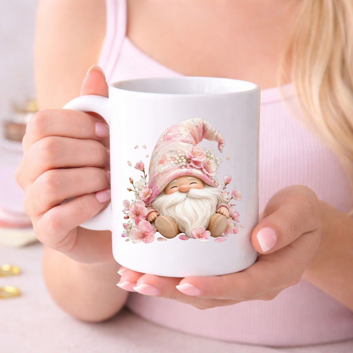 Cherry Blossom Gnome UV DTF sticker applied to a white coffee mug held in both hands