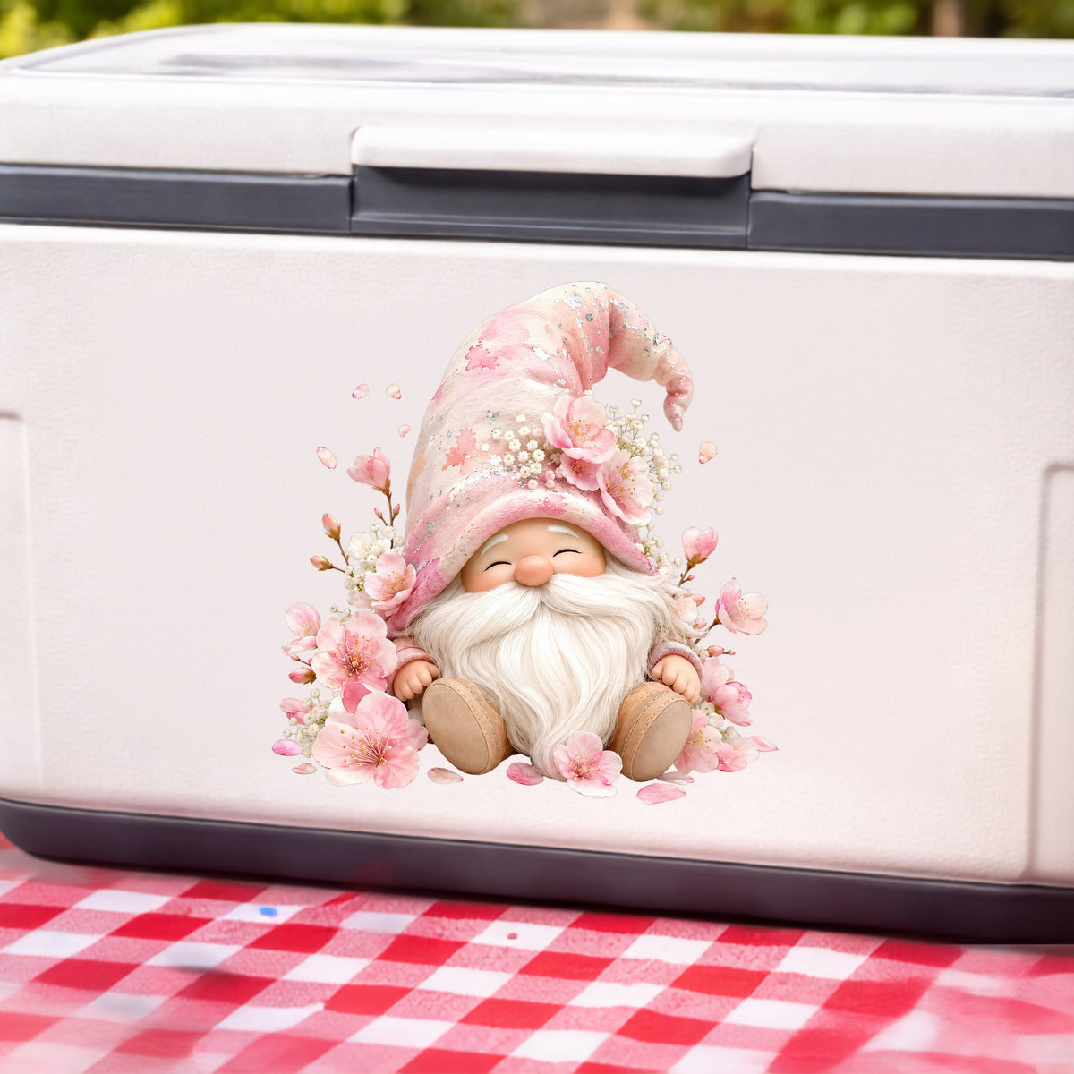 Cherry Blossom Gnome UV DTF sticker applied to a white cooler on a red gingham cloth