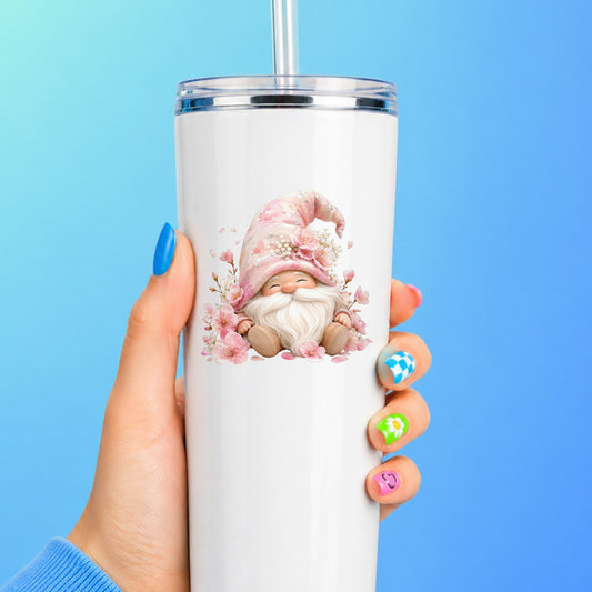 Cherry Blossom Gnome UV DTF sticker applied to a white straw tumbler on a blue background