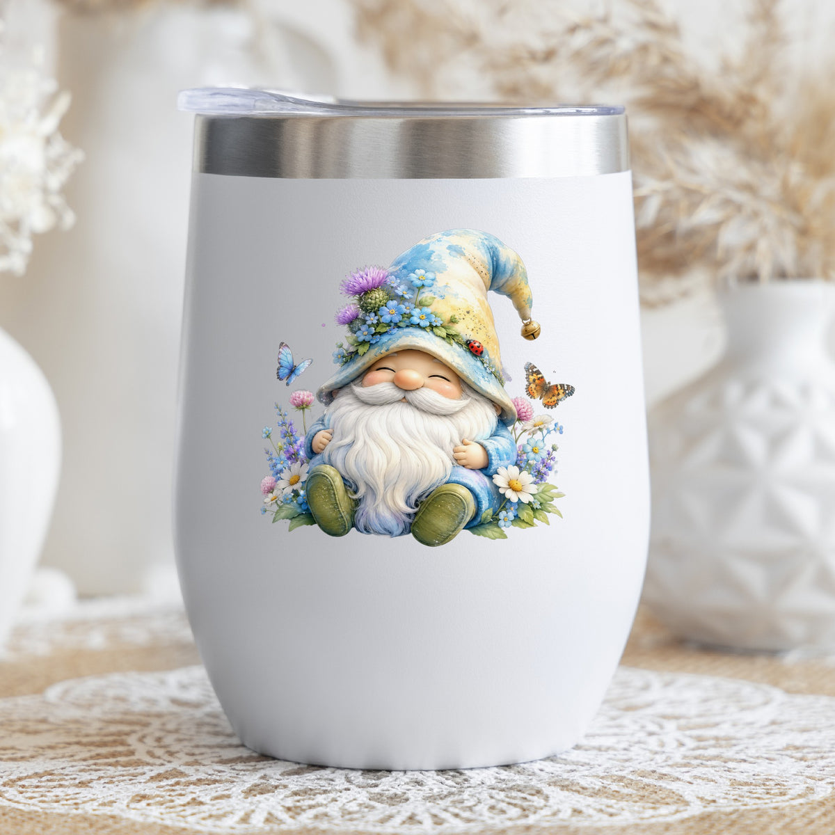 Wildflower Gnome With Butterflies UV DTF sticker applied to a white stemless tumbler with a lid