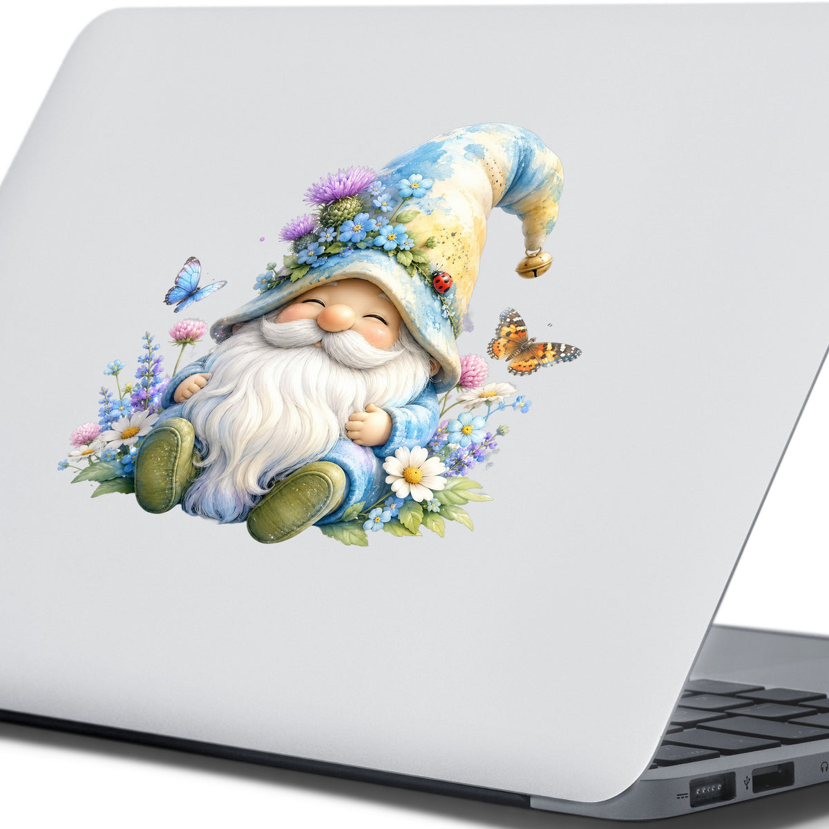 Wildflower Gnome With Butterflies UV DTF sticker applied to the lid of a silver laptop