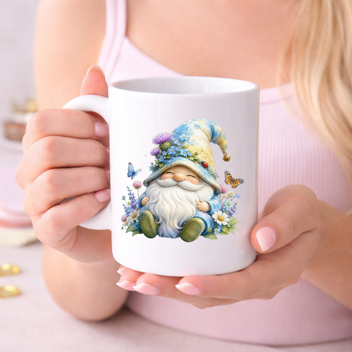 Wildflower Gnome With Butterflies UV DTF sticker applied to a white coffee mug held in both hands