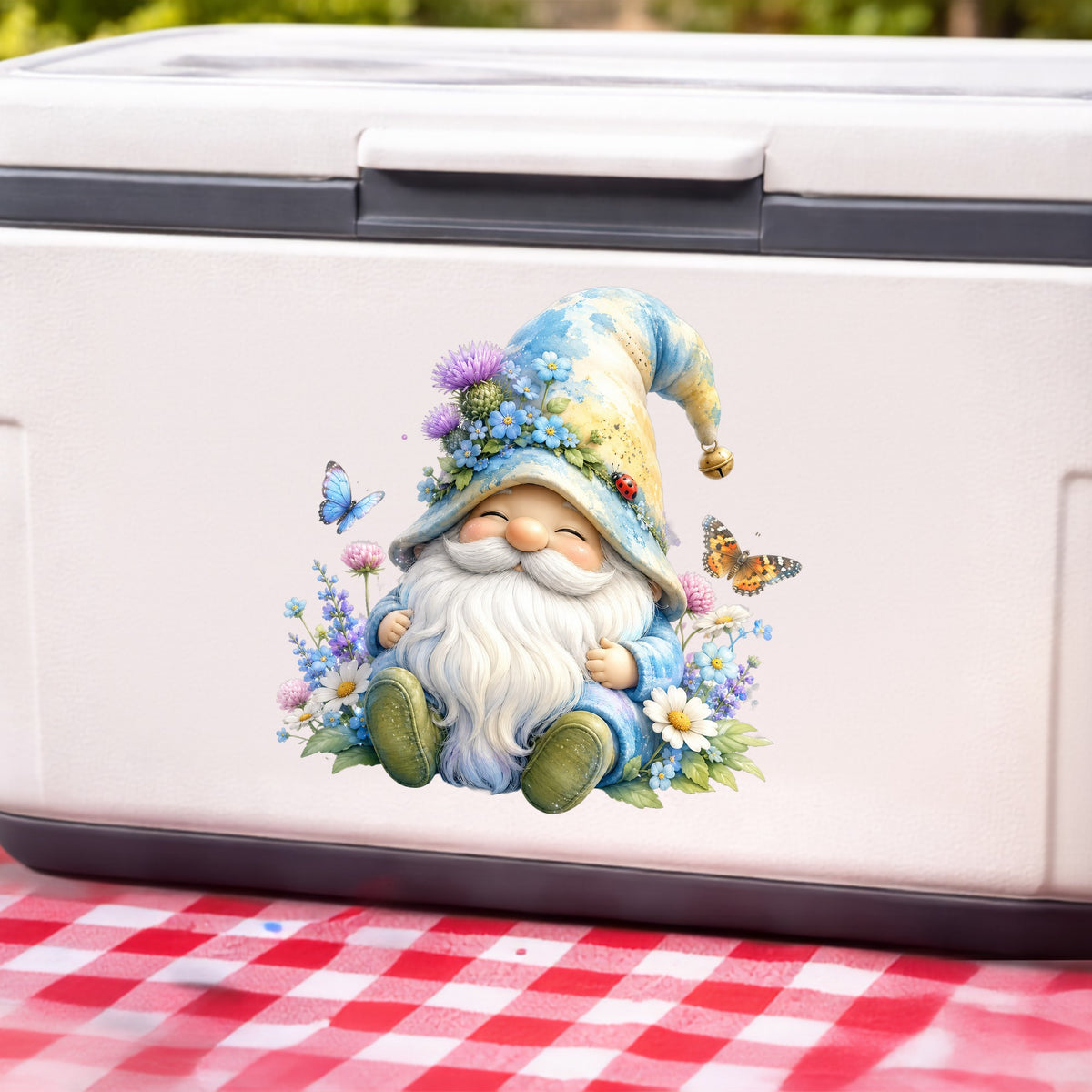 Wildflower Gnome With Butterflies UV DTF sticker applied to a white cooler on a red gingham cloth
